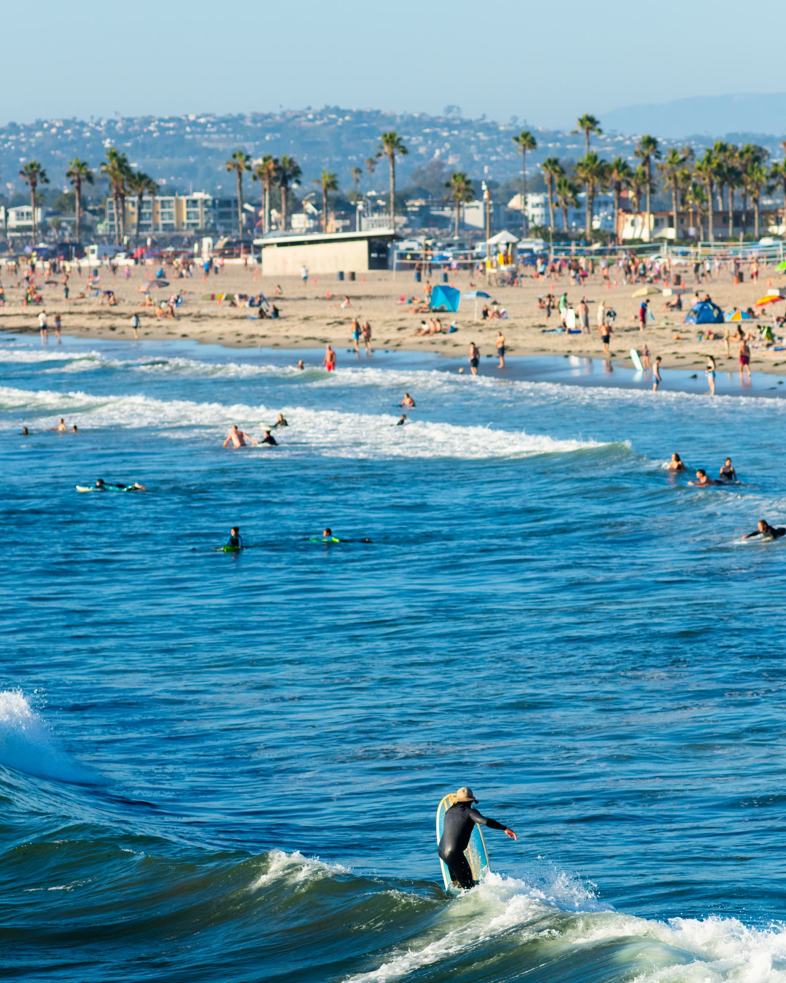 Surfers Surfing at Ocean Beach Pier on a Sunny San Diego Day