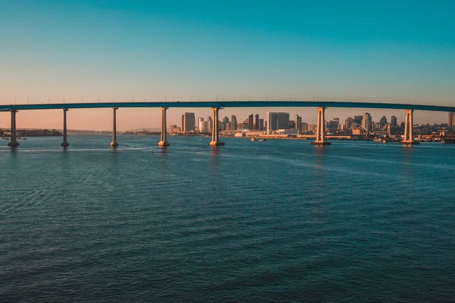 Helicopter shot of the Coronado Bridge with Downtown San Diego in the Background during Sunset | Photo – 6