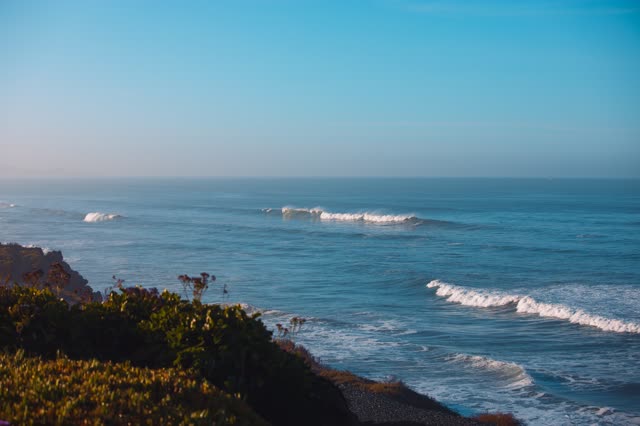Elevated view of the cliffs, the surf and the ocean in Del Mar.