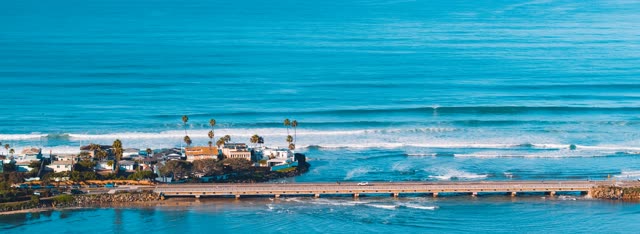 Aerial view of the beach, the surf and the bridge in Del Mar.