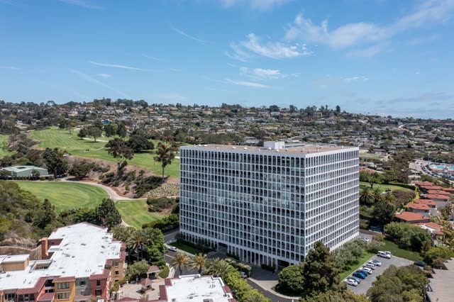 Aerial view of a residential street, palm trees and homes at La Jolla Country Club.