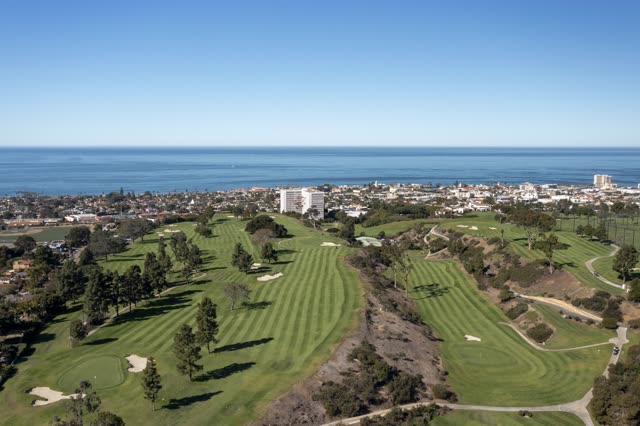 Aerial view of the country inland, the skyline and palm trees at La Jolla Country Club.