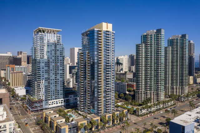 Low aerial view of the downtown streets, the skyline and palm trees at Waterfront.