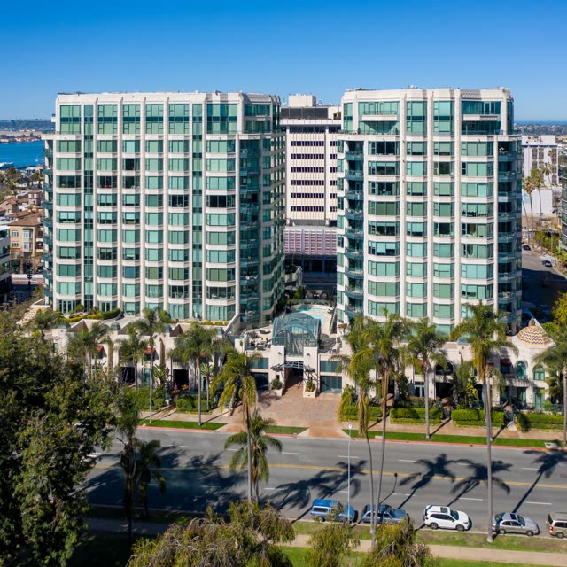 Low aerial view of the downtown streets, palm trees and the bay at Bankers Hill.