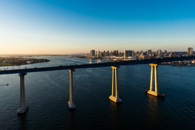 Helicopter shot of the Coronado Bridge with Downtown San Diego in the Background during Sunset | Photo