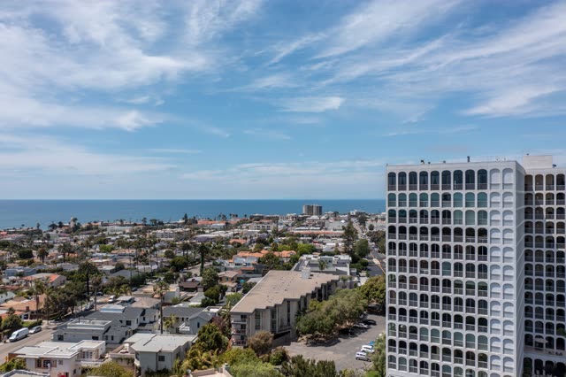 Aerial view of a residential street, palm trees and the ocean at La Jolla Country Club.