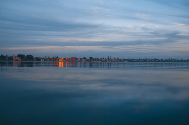 View from the water of the beach, palm trees and the bay in Mission Bay.