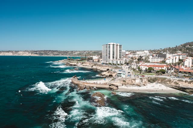 Aerial view of the beach, the surf and the ocean at La Jolla Cove.
