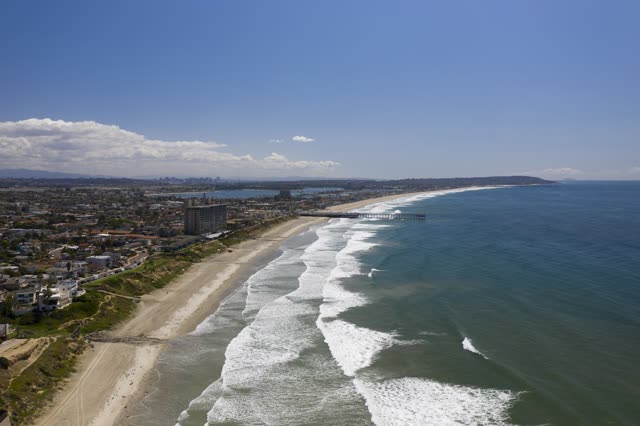 Aerial view of the beach, the surf and the pier in Pacific Beach.