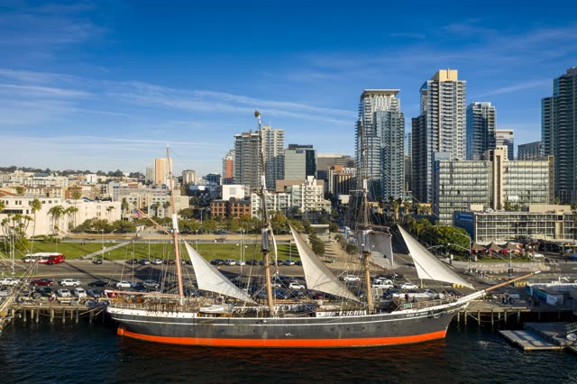 Low aerial view of the downtown streets, the skyline and boats at Waterfront.