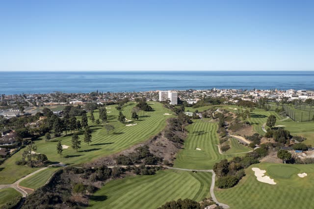 Aerial view of the country inland, the skyline and the ocean at La Jolla Country Club.