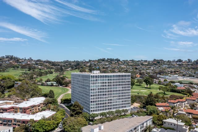 Aerial view of a residential street, palm trees and homes at La Jolla Country Club.
