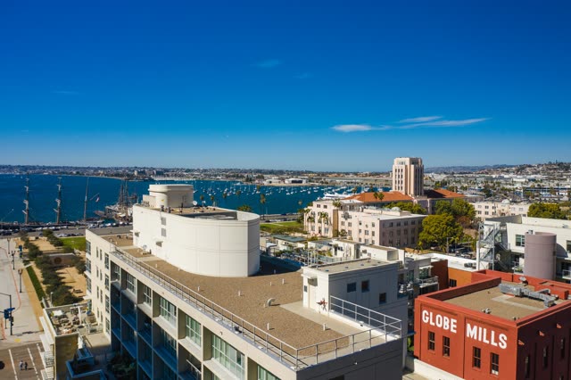 Low aerial view of the downtown streets, boats and palm trees at Waterfront.
