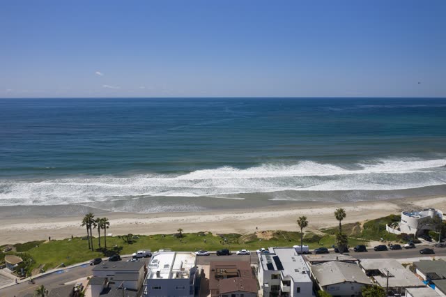 Aerial view of the beach, the surf and palm trees in Pacific Beach.