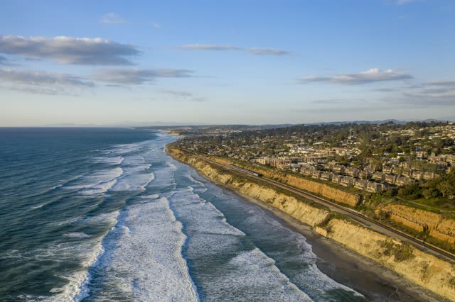 Aerial view of the cliffs, the surf and the ocean in Del Mar.