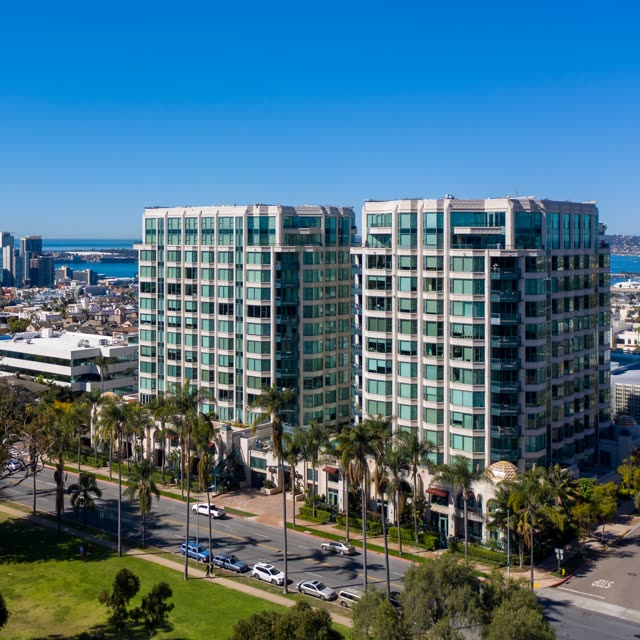 Low aerial view of the downtown streets, the skyline and palm trees at Bankers Hill.