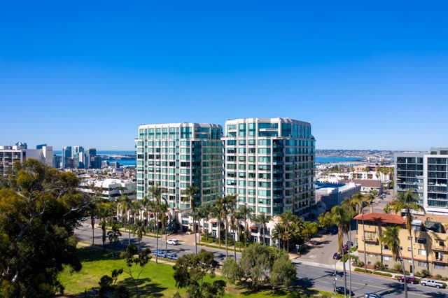 Low aerial view of the downtown streets, the skyline and palm trees at Bankers Hill.