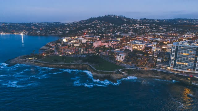 Aerial view of the cliffs, the surf and the ocean at La Jolla Cove.