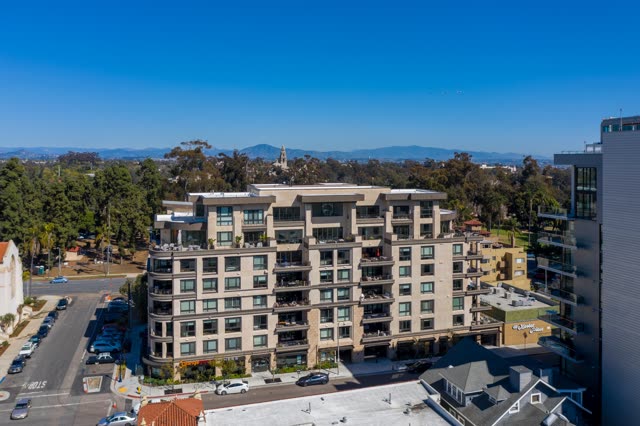 Low aerial view of a residential street, homes and the buildings at Bankers Hill.
