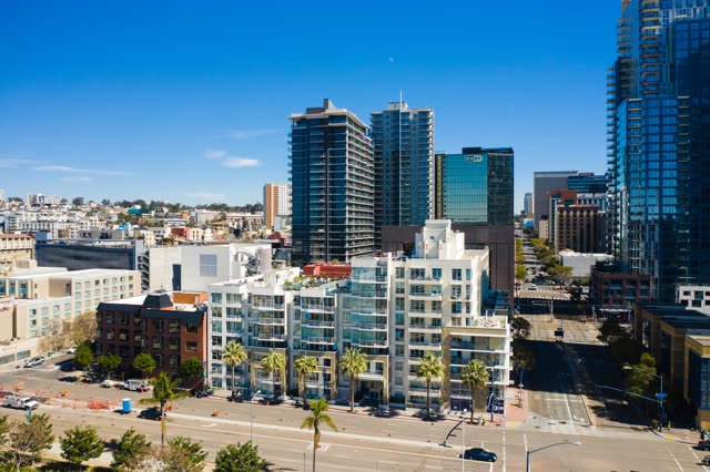 Low aerial view of the downtown streets, the skyline and palm trees at Waterfront.