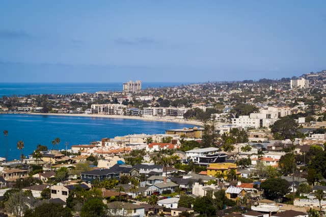 Elevated view of a residential street, palm trees and the ocean in Mission Bay.
