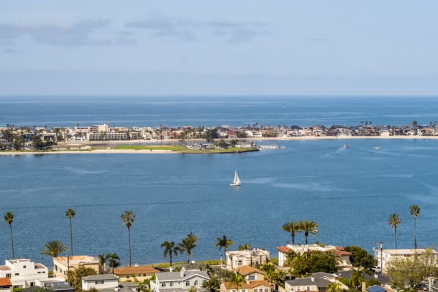 Elevated view of a residential street, boats and palm trees in Mission Bay, with boats out.