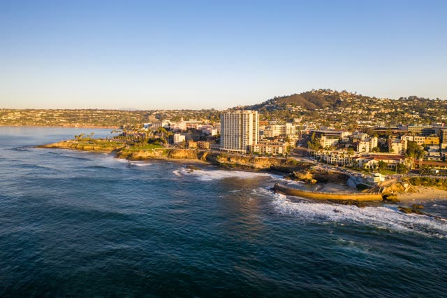 Aerial view of the cliffs, the surf and the ocean at La Jolla Cove.