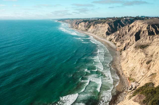 Aerial view of the cliffs, the surf and the ocean at La Jolla Farms.