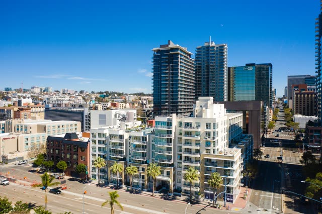 Low aerial view of the downtown streets, the skyline and palm trees at Waterfront.