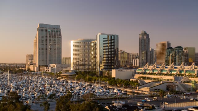Low aerial view of the downtown streets, the skyline and boats at Embarcadero.