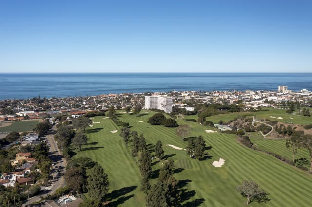 Aerial view of the country inland, the ocean and homes at La Jolla Country Club.