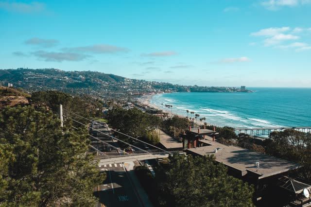 Aerial view of the cliffs, the surf and the pier at La Jolla Farms.