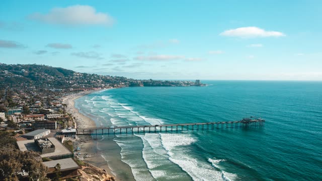 Aerial view of the beach, the surf and the pier at La Jolla Farms.