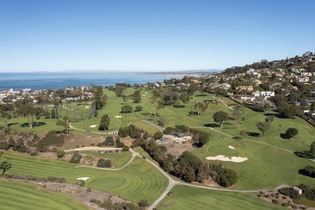 Aerial view of the country inland, the ocean and homes at La Jolla Country Club.