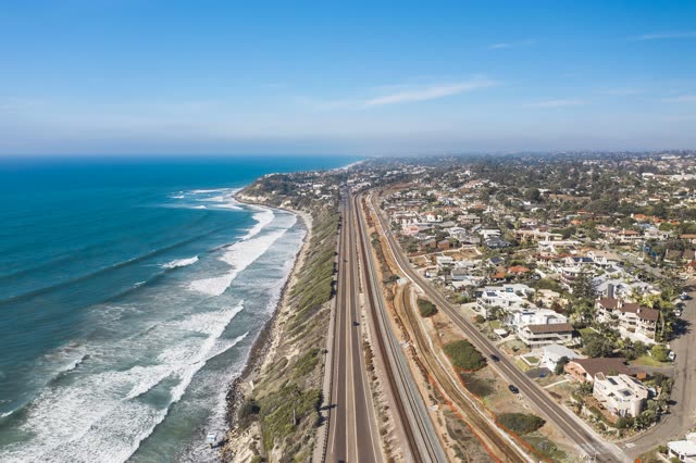 Aerial view of a residential street, the surf and the ocean in Cardiff.