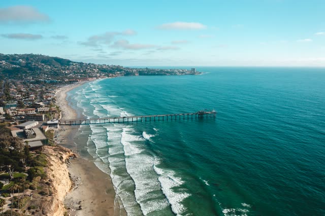 Aerial view of the cliffs, the surf and the pier at La Jolla Farms.
