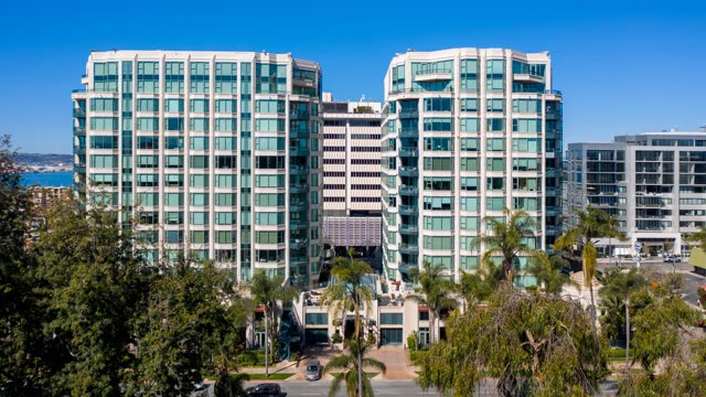 Low aerial view of the downtown streets, palm trees and the bay at Bankers Hill.