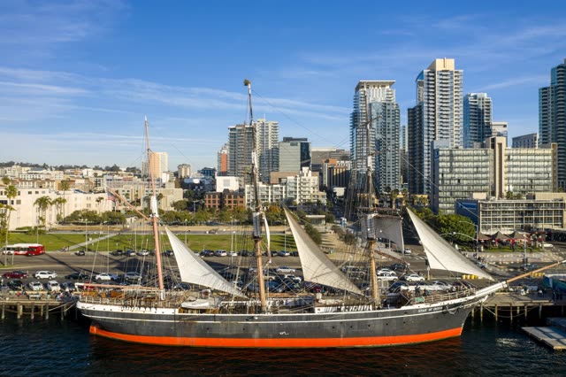 Low aerial view of the harbor, the skyline and boats at Waterfront.
