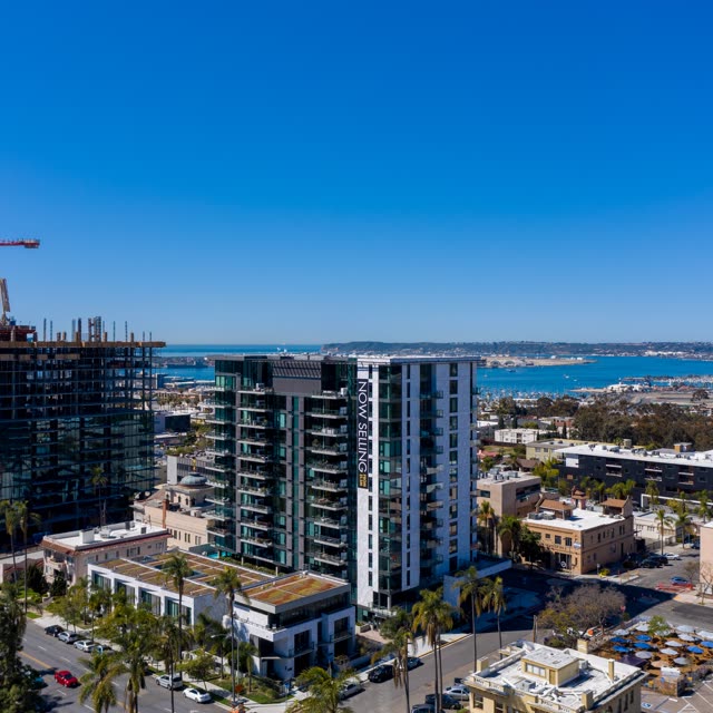 Aerial view of the downtown streets, palm trees and the bay at Bankers Hill, with a work crew on site.