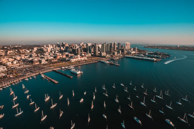 Aerial view of the downtown streets, the skyline and boats at San Diego Marina, with boats out.