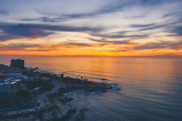 Aerial view of the cliffs, palm trees and the ocean at La Jolla Cove.