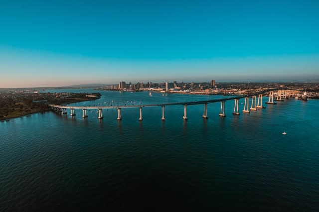 Helicopter shot of the Coronado Bridge with Downtown San Diego in the Background during Sunset | Photo – 3