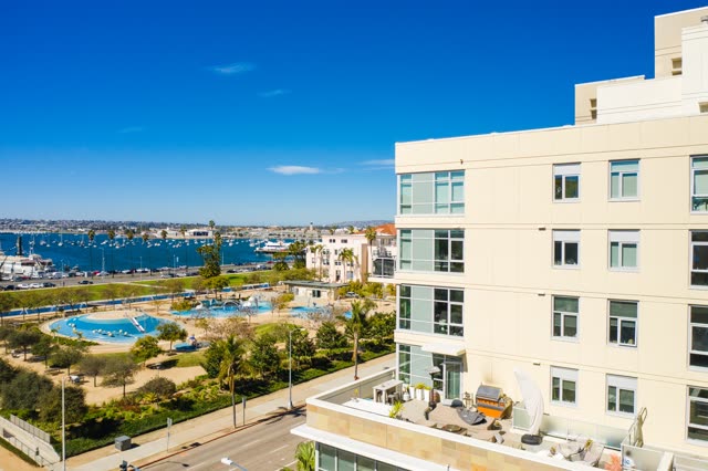 Low aerial view of the downtown streets, boats and palm trees at Waterfront.