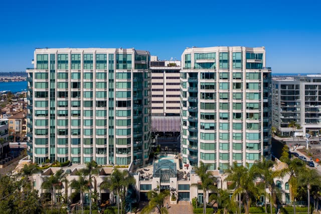 Low aerial view of the downtown streets, palm trees and the bay at Bankers Hill.