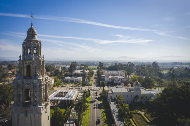 Low aerial view of a park, palm trees and the buildings in Balboa Park.