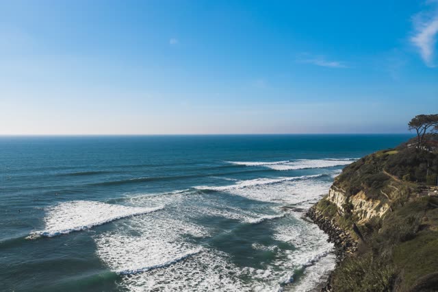Aerial view of the cliffs, the surf and the ocean at Swamis.