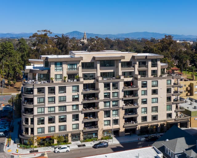 Low aerial view of a residential street, homes and the buildings at Bankers Hill.