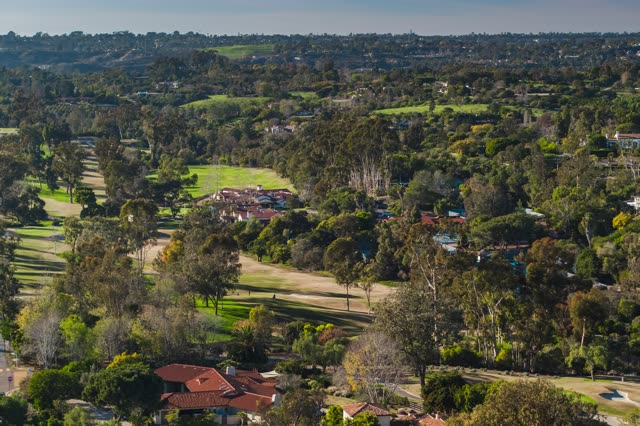 Aerial view of a residential street, homes and open country at Covenant.