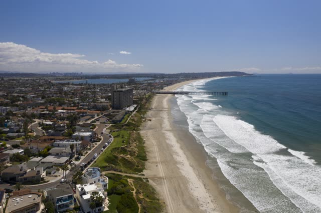 Aerial view of the beach, the surf and the pier in Pacific Beach.