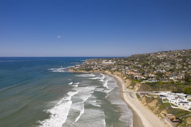 Aerial view of the cliffs, the surf and the ocean in Pacific Beach.